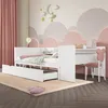A white children's bed with drawers and a desk attachment, set in a child's bedroom with cloud-themed wall decor and pink curtains. Produktbild-Vorschau