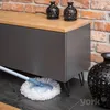A mop is cleaning the floor under a piece of furniture with a wooden top. Podgląd zdjęcia produktu