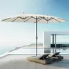 A large, cream-colored double patio umbrella stands over two lounge chairs next to a swimming pool with a modern white building in the background. Produktbild-Vorschau
