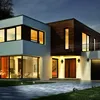 A modern house at dusk with exterior lighting. Produktbild-Vorschau