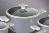 A close-up shot of a set of gray pots with white handles and lids. Podgląd zdjęcia produktu