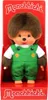 A Monchhichi doll wearing a frog-themed outfit, presented in its retail packaging. Náhled obrázku produktu