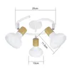 A white ceiling light fixture with three adjustable spotlights, each featuring a wooden accent. Voir les images du produit