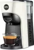A white and black Lavazza capsule coffee machine with a glass cup of espresso in front of it. Produktbild-Vorschau