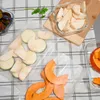 A top-down view of sliced vegetables and fruits laid out on a checkered tablecloth, possibly for food preparation or storage. Náhled obrázku produktu