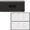 A black spiral-bound desk calendar for the year 2026 is shown open, displaying a weekly layout. Produktbild-Vorschau