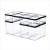 A set of clear plastic food storage containers with black lids, arranged in two rows. Produktbild-Vorschau