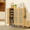 A shoe cabinet with its doors open, displaying shoes on shelves, with boots and a handbag on the side. Podgląd zdjęcia produktu