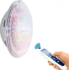A hand holding a remote control and a light bulb. Produktbild-Vorschau