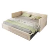 A beige upholstered daybed with green bedding and pillows, shown in an open configuration with a pull-out bed and storage drawers. Podgląd zdjęcia produktu
