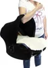 A person is holding a baby car seat with a black cover and a white liner. Náhled obrázku produktu