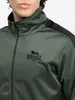 Close-up of a man wearing a green Lonsdale tracksuit jacket. Anteprima dell’immagine prodotto