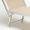 Close-up of the leg and fabric of a beige and silver lounge chair. Produktbild-Vorschau