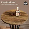 A round wooden table with a bottle of rum and a glass on it. Produktbild-Vorschau