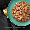 A close-up of cat food on a teal plate with a gold fork and dark fabric. Produktbild-Vorschau