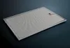A metal range hood filter is shown from a slightly elevated angle against a dark background. Voir les images du produit