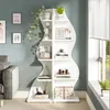 A white, wavy bookshelf filled with decorative items and plants, placed in a room with a gray couch and a blue wall. Podgląd zdjęcia produktu