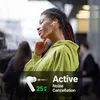 A woman wearing earbuds in a public setting. Produktbild-Vorschau