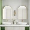 A modern bathroom vanity with two arched mirrors, sinks, and faucets. Produktbild-Vorschau