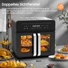 A black dual-zone air fryer with food inside, placed on a countertop with some food items around it. Produktbild-Vorschau