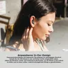 A woman wearing earbuds outdoors. Produktbild-Vorschau