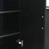 A close-up view of the interior of a black cabinet, showing shelves and a hinge. Podgląd zdjęcia produktu