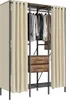 A freestanding closet organizer with clothing hanging on a rack and two drawers. Produktbild-Vorschau
