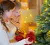 A mother and child decorating a Christmas tree. Produktbild-Vorschau