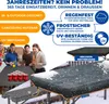 A group of people are playing beer pong indoors, with a table covered by a protective cover in the snow in the foreground. Produktbild-Vorschau