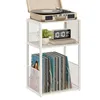 A white three-tier shelf unit holding a record player on the top shelf, a digital clock and a small plant on the middle shelf, and vinyl records on the bottom shelf. Produktbild-Vorschau