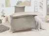 A bed with winter bedding in a room with a window. Produktbild-Vorschau