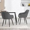 Two dark gray dining chairs are placed around a white dining table in a well-lit room. Produktbild-Vorschau
