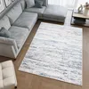 A modern living room with a sectional sofa and a rug.