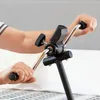 Close-up of a person's hands using a pedal exerciser. Produktbild-Vorschau