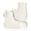 A pair of white shoe covers on a white background. Anteprima dell’immagine prodotto