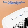 A close-up view of the top panel of a white dehumidifier, showing its control interface and a vent. The background is a light brown wooden surface. Produktbild-Vorschau