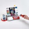 A toy cash register with accessories and a hand holding a scanner. Produktbild-Vorschau