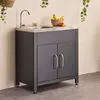 An outdoor kitchen unit with a sink and faucet, set against a neutral wall and floor. Anteprima dell’immagine prodotto