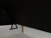 A close-up view of the corner of a black boxspring bed frame, showing a metal hinge mechanism and a wooden support. Produktbild-Vorschau