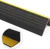 A close-up, angled view of a black and yellow stair nosing profile with a ribbed surface. Produktbild-Vorschau