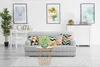 A living room scene with a sofa, coffee table, and artwork. Produktbild-Vorschau