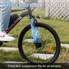 A person is riding an electric bicycle on a grassy path, with text overlays highlighting features. Produktbild-Vorschau