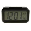 A digital alarm clock is shown on a light gray background. Náhled obrázku produktu