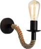 A single wall lamp with a black base and a rope arm holding a light bulb. Náhľad obrázku produktu