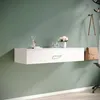 A white floating shelf with a drawer is mounted on a green wall, decorated with a vase of flowers and a handbag hanging on a coat rack. Anteprima dell’immagine prodotto
