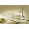 A modern living room setting with a sofa, side tables, and decorative items. Podgląd zdjęcia produktu