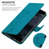 A teal flip phone case with a floral pattern is shown open, revealing a smartphone screen. Náhled obrázku produktu