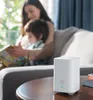 A woman and child are on a couch in a living room, reading a book. A white Eufy device is on a coffee table in the foreground. Voir les images du produit