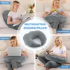 Collage showing a U-shaped pillow being used for reading, breastfeeding, working on a laptop, and gaming. Produktbild-Vorschau