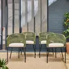 Four green outdoor chairs with beige cushions are arranged on a tan rug in front of a glass partition and a brick wall. Produktbild-Vorschau